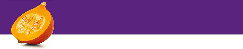 A halved pumpkin with seeds is presented against a purple background.