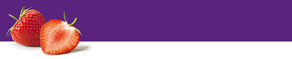 A strawberry, sliced in half, revealing its juicy red interior and tiny seeds, rests against a purple background.