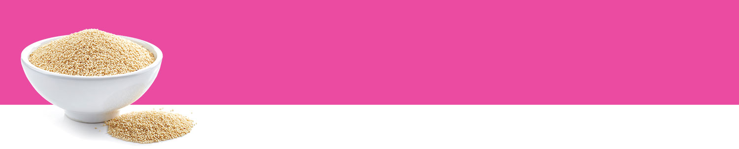 A white bowl filled with a granular substance sits on a white surface against a pink background.