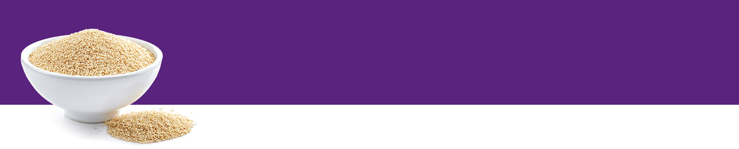 A white bowl filled with a granular substance sits on a white surface against a purple background.