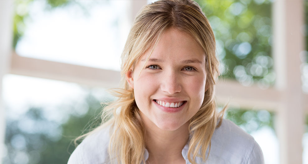 A smiling woman with blonde hair.